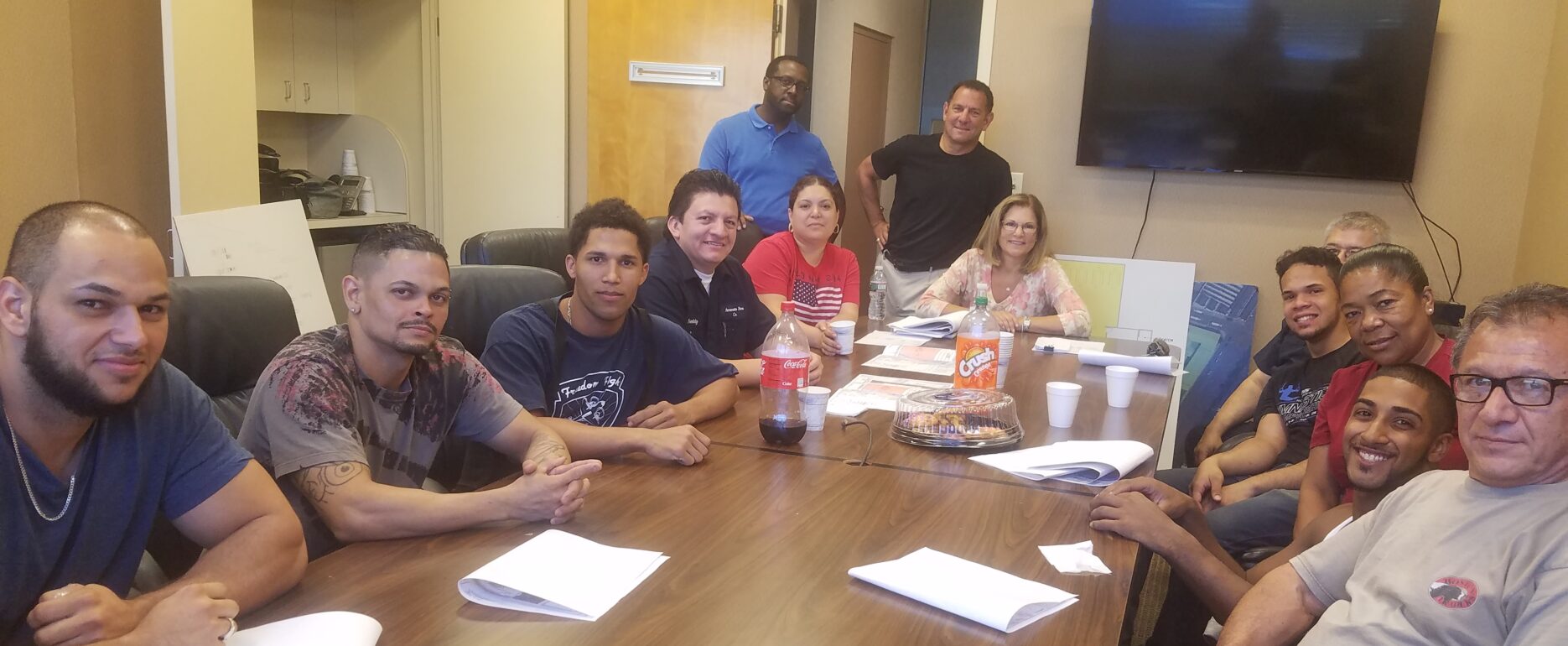 Accurate Box Company employees who completed the ESL program sitting around a table